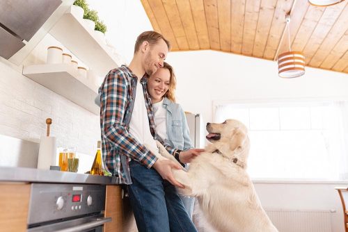 Un uomo e una donna con il loro cane in cucina 
